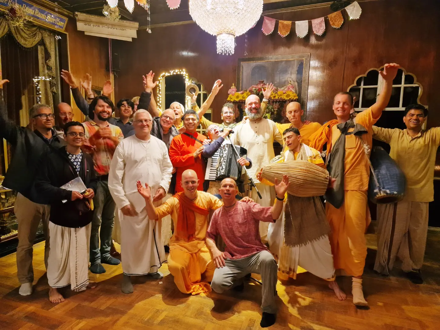 A group of musicians and guests celebrating together indoors