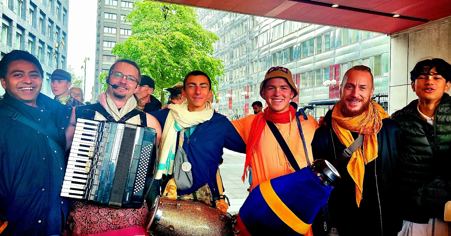 A kirtan procession moving through a Stockholm street
